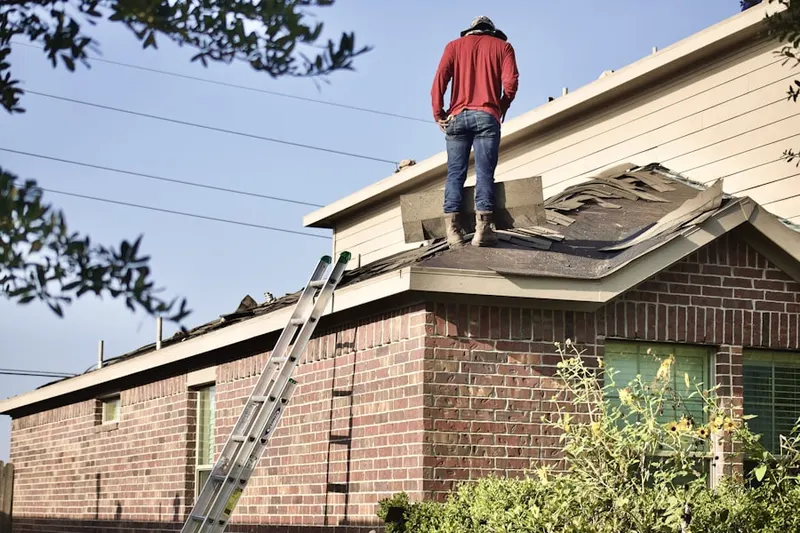 Professional roofer working on a residential roof in Surrey Place